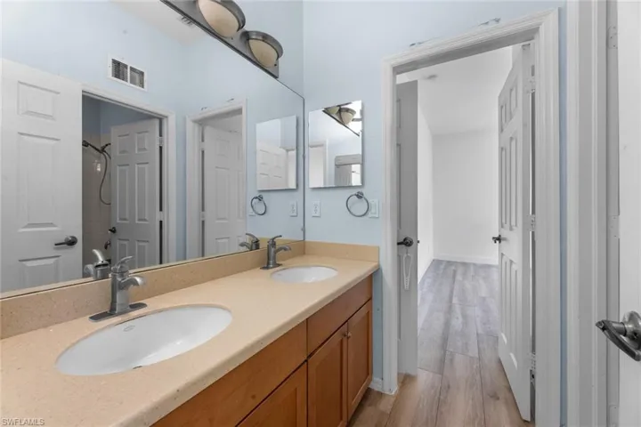 Bathroom featuring hardwood / wood-style floors and dual bowl vanity