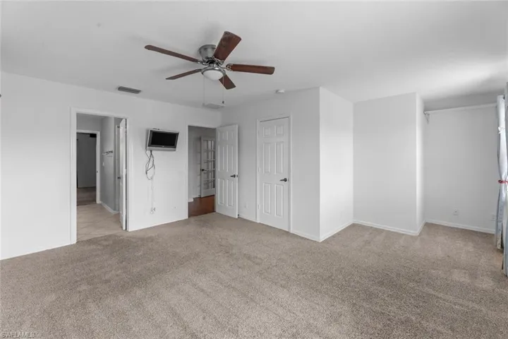 Master bedroom Unfurnished bedroom with light colored carpet and ceiling fan