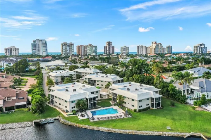 Drone / aerial view of a nearby body of water and city skyline