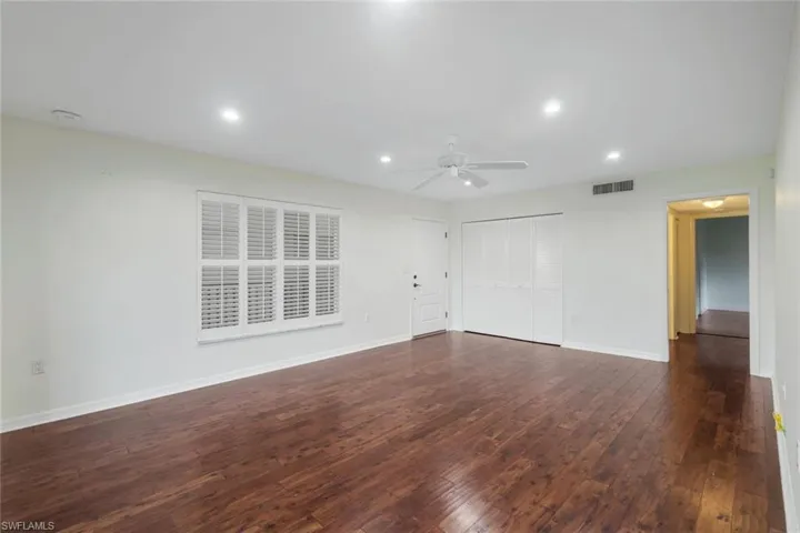 Unfurnished living room featuring recessed lighting, dark wood finished floors, and ceiling fan