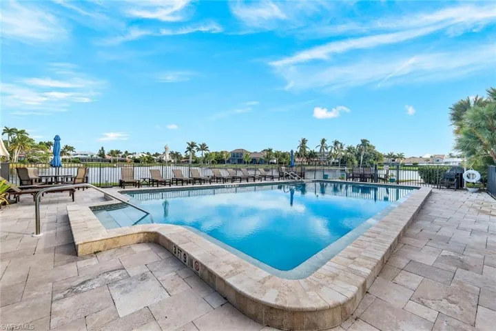 Community pool featuring a patio and area for grilling