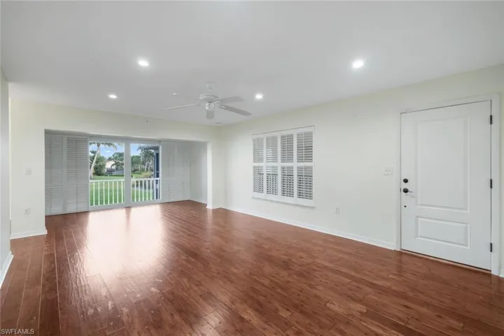 Unfurnished living room featuring dark wood-type flooring, recessed lighting, and a ceiling fan