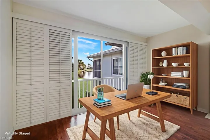 Office featuring dark wood finished floors and a water view