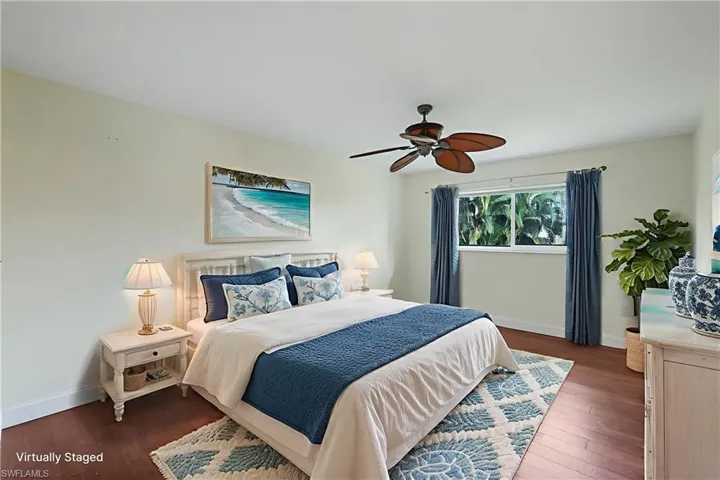 Bedroom featuring dark wood-style flooring and ceiling fan