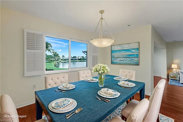Dining room featuring wood finished floors and a water view