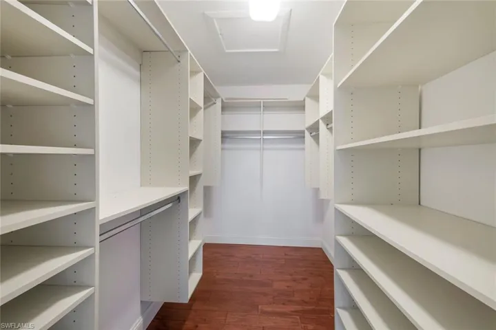 Spacious closet with dark wood finished floors