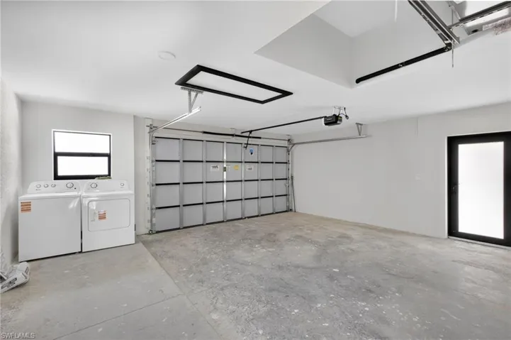Garage featuring independent washer and dryer