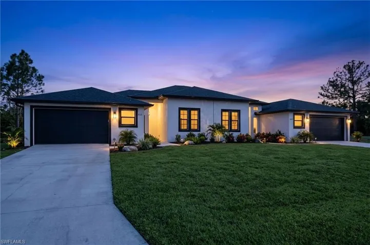 Prairie-style house with a yard, an attached garage, and concrete driveway