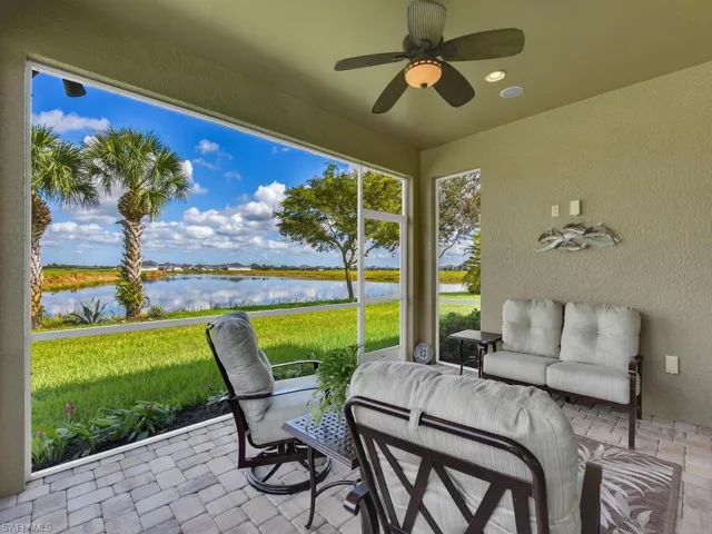 Sunroom with a water view and ceiling fan