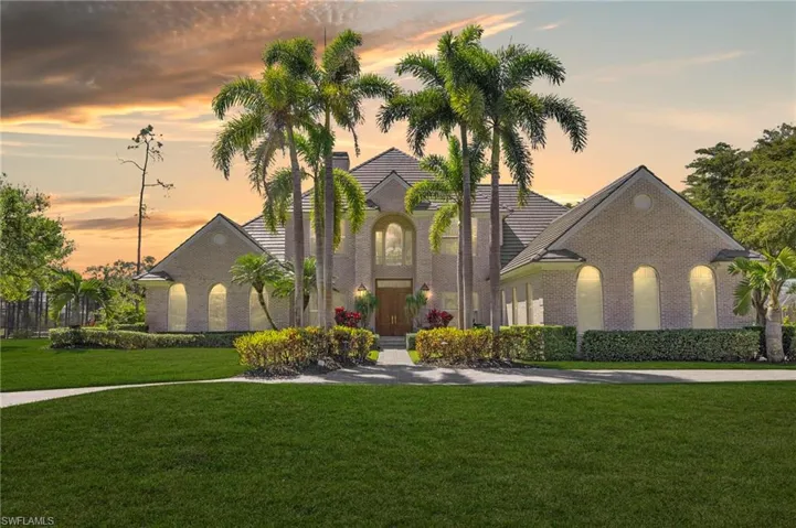 View of front of house with a front yard and brick siding