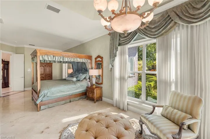 Bedroom with a chandelier, visible vents, baseboards, and ornamental molding