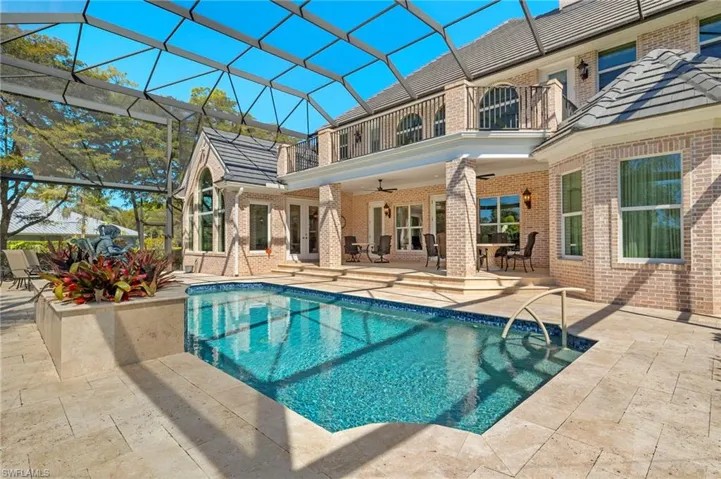 Pool with glass enclosure, a patio, french doors, and ceiling fan
