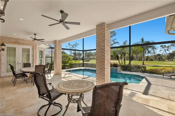 Outdoor pool featuring french doors, a lanai, a ceiling fan, and a patio area