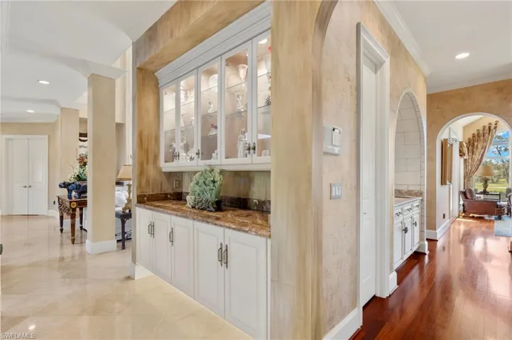 Bar featuring recessed lighting, baseboards, arched walkways, and ornamental molding