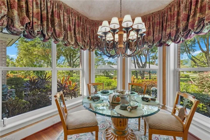 Sunroom featuring an inviting chandelier