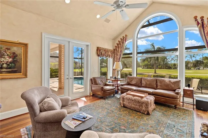 Sunroom with a ceiling fan, lofted ceiling, french doors, and visible vents