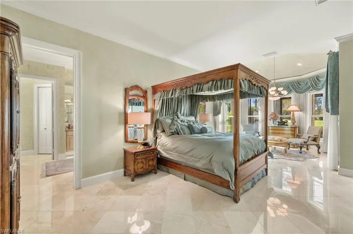 Bedroom with an inviting chandelier, access to exterior, baseboards, and ornamental molding