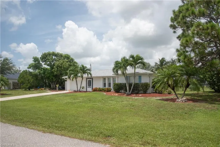 View of front of home featuring a garage and a front lawn