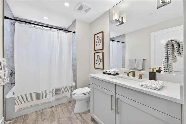 Bathroom 3 Full bathroom featuring shower / bath combo with shower curtain, vanity, and recessed lighting