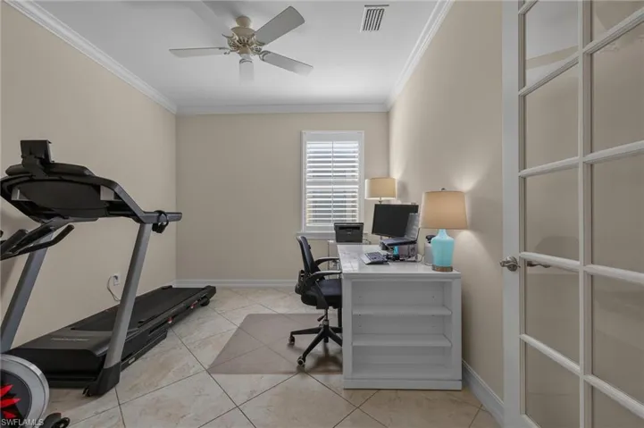 Versatile room featuring ceramic tile flooring, crown molding and French doors