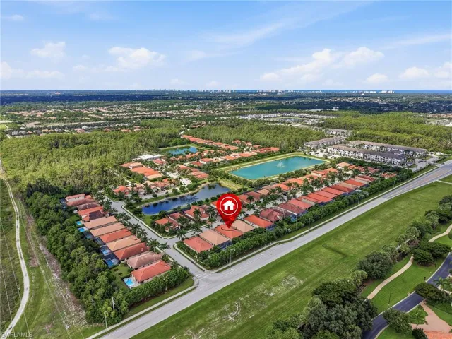 Aerial perspective showcasing a residential community with multiple lakes and abundant surrounding greenery