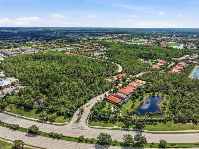 Expansive aerial showcasing a residential community amidst abundant natural landscaping and entrance from Livingston
