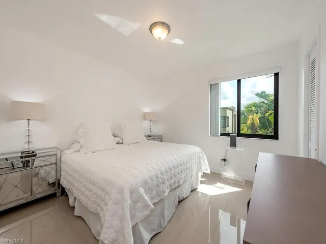 Bedroom with light tile patterned floors and baseboards