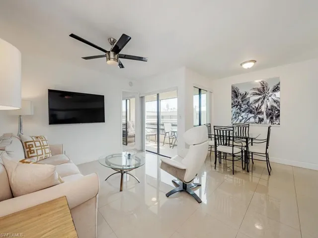 Tiled living area with baseboards and ceiling fan