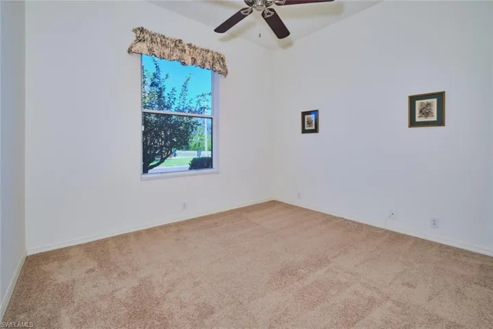 Spare room with carpet flooring and ceiling fan