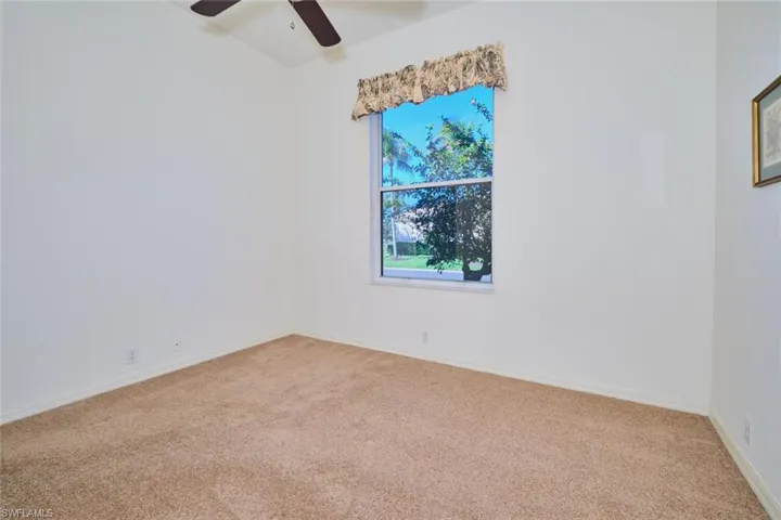Unfurnished room featuring carpet flooring and a ceiling fan