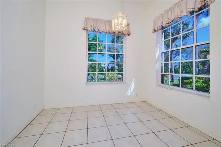 Unfurnished dining area featuring suspended lighting and light tile patterned flooring