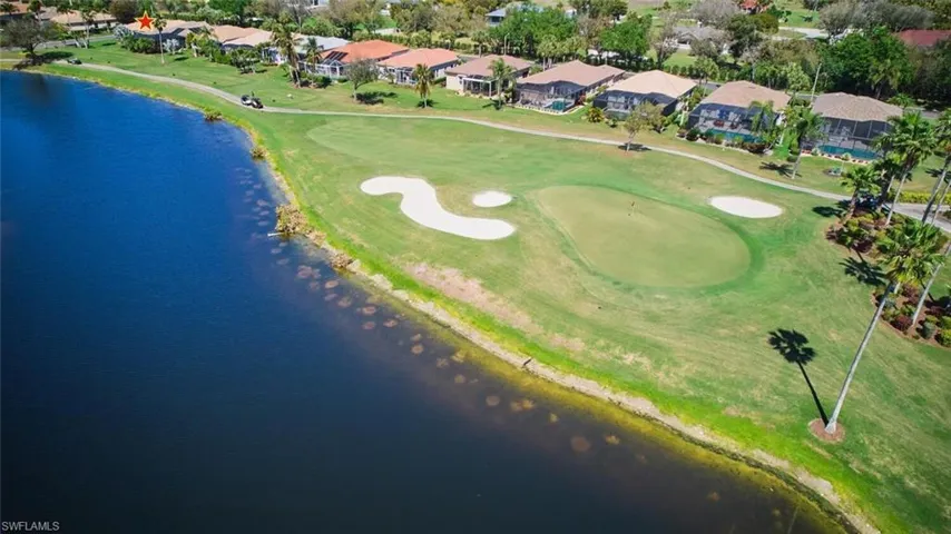 Aerial perspective of suburban area with a large body of water and a local golf course