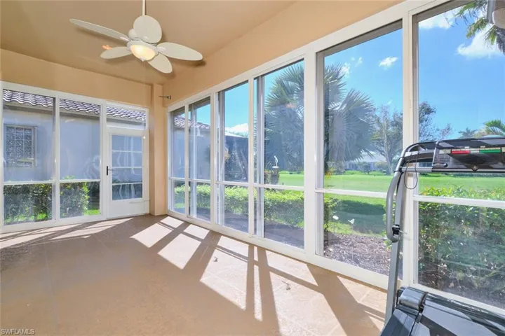 Unfurnished sunroom with ceiling fan