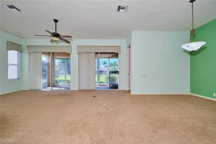 Empty room featuring carpet and ceiling fan