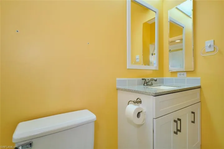 Half bathroom with vanity and toilet