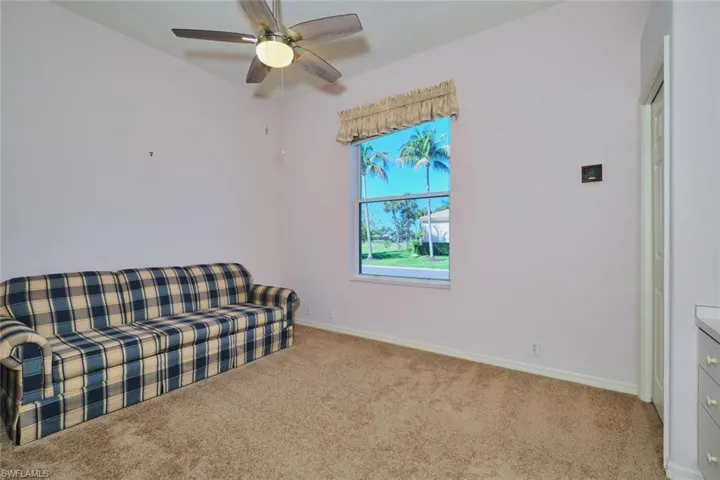 Sitting room featuring light carpet and ceiling fan