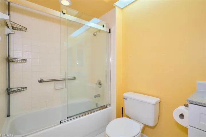 Full bathroom with vanity and shower / bath combination with glass door