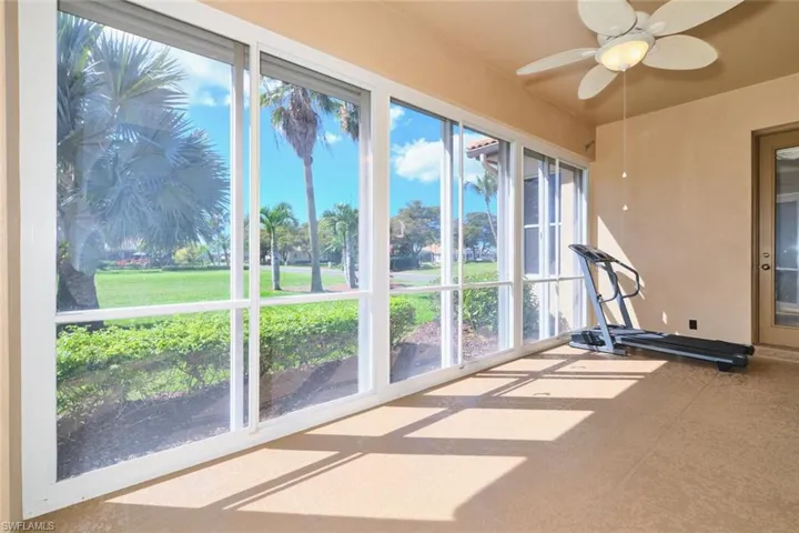 Unfurnished sunroom featuring ceiling fan