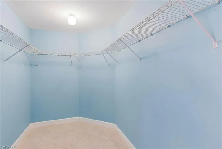 Walk in closet featuring light tile patterned flooring