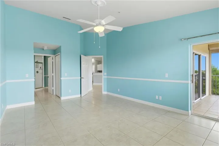 Unfurnished room with ceiling fan and light tile patterned floors