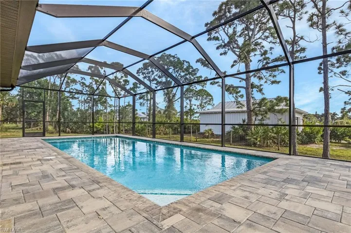 View of pool with a lanai and a patio