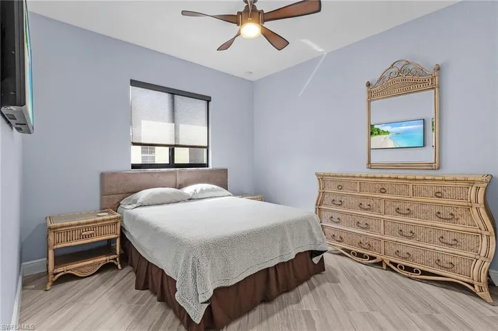 Bedroom with hardwood / wood-style flooring and ceiling fan