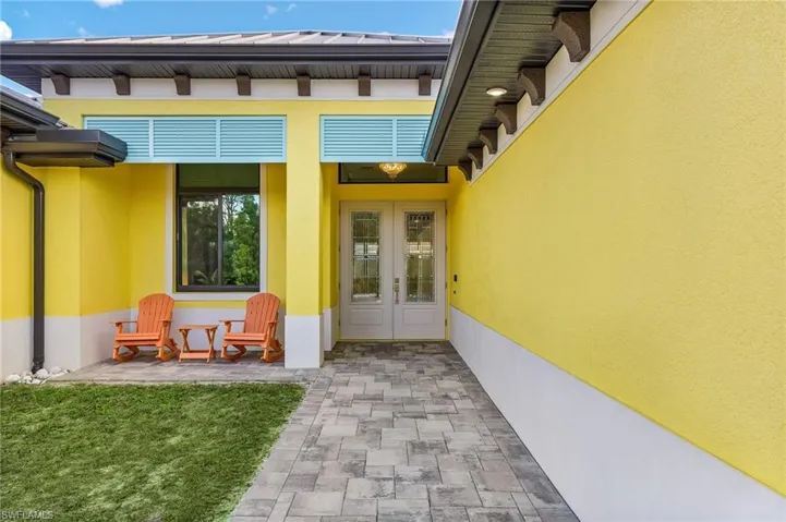 Property entrance featuring french doors and a patio area