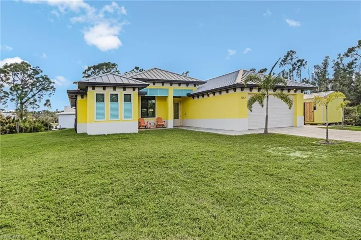 View of front of home featuring a garage and a front yard