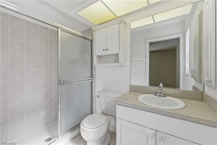 Full bath with vanity and a shower stall
