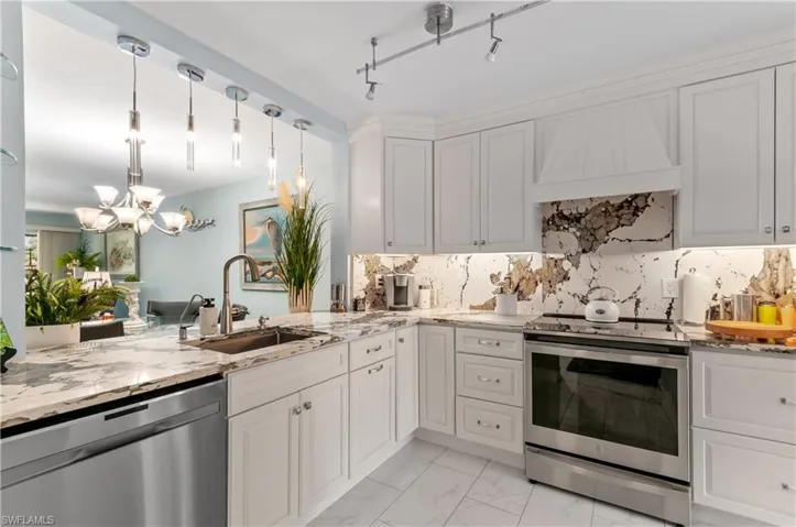 Modern kitchen featuring light cabinetry, Quartz stone countertops, stainless steel appliances, Quartz stone backsplash, and recessed lighting