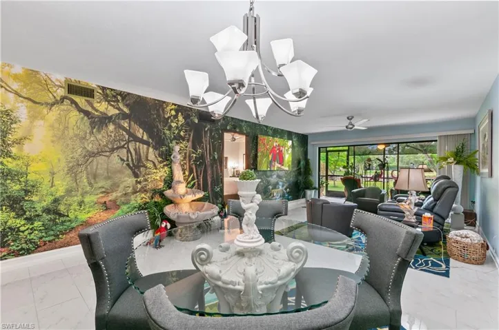Open-concept interior featuring a prominent wall mural, white tile flooring, and a contemporary ceiling fan