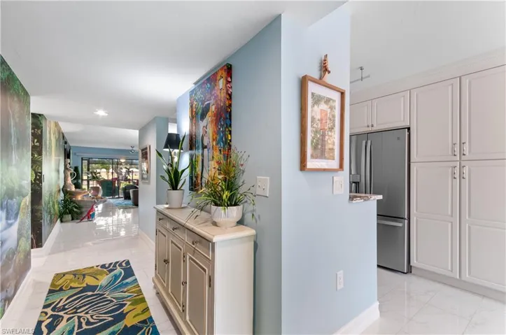 Entry area featuring light porcelain tile flooring throughout