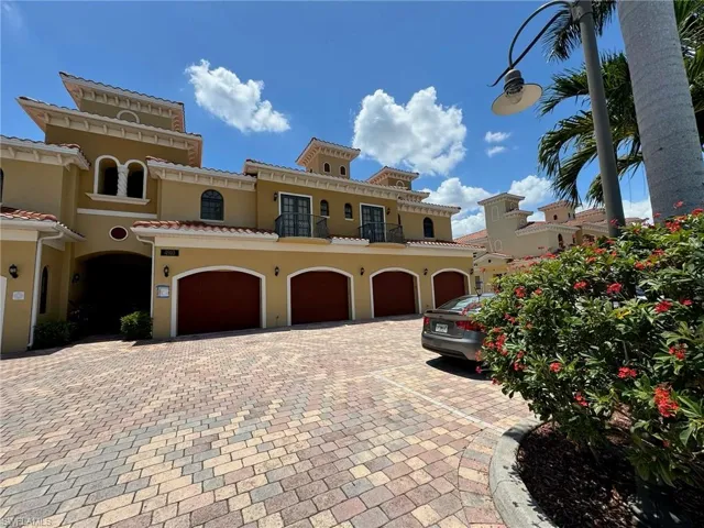 Mediterranean / spanish-style townhome with a garage
