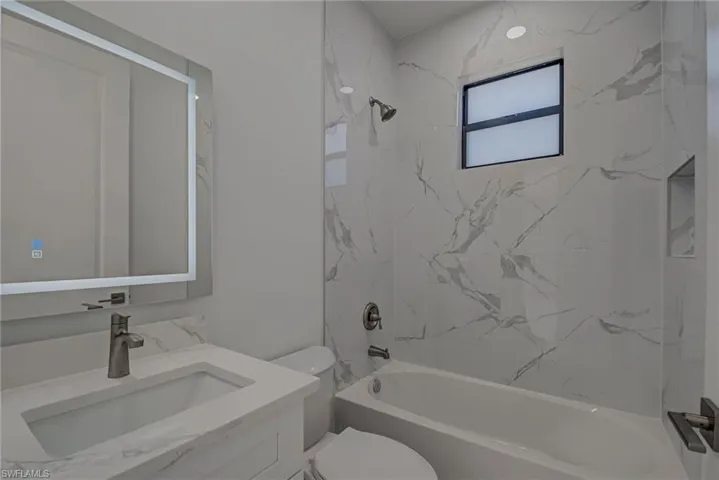 Bathroom with vanity and bathing tub / shower combination